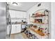 Bright kitchen with white cabinets, granite countertops, and a decorative shelving unit at 1150 Rankin St # 19O, Stone Mountain, GA 30083