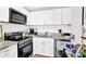 Updated kitchen with stainless steel appliances, granite countertops, and white cabinetry at 1150 Rankin St # 19O, Stone Mountain, GA 30083