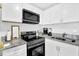 Modern kitchen featuring white cabinets, stainless steel appliances and granite countertops at 1150 Rankin St # 19O, Stone Mountain, GA 30083