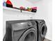 Modern laundry room featuring Samsung washer and dryer with white shelving for organized storage at 1150 Rankin St # 19O, Stone Mountain, GA 30083