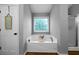 Bathroom features a soaking tub with tray and a charming decor sign on the door at 137 Cambridge Pointe, Villa Rica, GA 30180