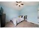 This bedroom is filled with natural light and has light blue walls and neutral carpet at 137 Cambridge Pointe, Villa Rica, GA 30180
