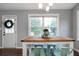 Dining room featuring hardwood floors, a window providing natural light, and a stylish chandelier at 137 Cambridge Pointe, Villa Rica, GA 30180