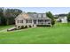Charming home featuring manicured lawn, inviting porch, and dormer windows at 137 Cambridge Pointe, Villa Rica, GA 30180
