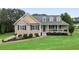 Charming single-Gathering home featuring a well-manicured lawn, lovely landscaping, and a welcoming front porch at 137 Cambridge Pointe, Villa Rica, GA 30180