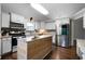 Modern kitchen with granite countertops, island breakfast bar, and stainless steel appliances at 137 Cambridge Pointe, Villa Rica, GA 30180