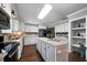 Bright open kitchen featuring granite countertops, backsplash, island breakfast bar and stainless appliances at 137 Cambridge Pointe, Villa Rica, GA 30180