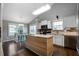 Bright kitchen with an island breakfast bar, white cabinets, and stainless steel appliances at 137 Cambridge Pointe, Villa Rica, GA 30180