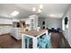 Open-concept kitchen with hardwood floors, stainless steel appliances, and island breakfast bar at 137 Cambridge Pointe, Villa Rica, GA 30180