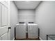 Laundry room with a new washer, dryer and shelving for supplies at 137 Cambridge Pointe, Villa Rica, GA 30180