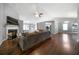 Bright living room with a fireplace, wood floors, and lots of natural light at 137 Cambridge Pointe, Villa Rica, GA 30180