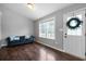 Comfortable living room with dark hardwood floors, a window, and a dark blue couch with pillows at 137 Cambridge Pointe, Villa Rica, GA 30180
