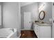 Bathroom featuring double sinks, a large soaking tub, and great natural light at 137 Cambridge Pointe, Villa Rica, GA 30180
