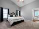 Bright main bedroom with a comfortable bed, soft carpet, and ensuite bathroom at 137 Cambridge Pointe, Villa Rica, GA 30180