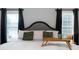 A beautifully staged bed, complete with tray, pillows, and bedside table at 137 Cambridge Pointe, Villa Rica, GA 30180