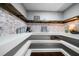 Bright pantry with brick detail, floating wooden shelving and ample storage at 137 Cambridge Pointe, Villa Rica, GA 30180