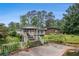 Backyard showcasing a multi-level deck, overgrown vegetation, and an in-ground pool at 2549 Emerald Dr, Jonesboro, GA 30236