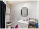 Bathroom with a white vanity, mirror, toilet, and black shower curtain at 2549 Emerald Dr, Jonesboro, GA 30236