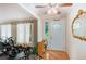 Inviting foyer with hardwood floors, decorative mirror, and natural light streaming through a glass-paneled front door at 2549 Emerald Dr, Jonesboro, GA 30236
