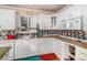 Well-lit kitchen featuring white cabinets and a dark backsplash at 2549 Emerald Dr, Jonesboro, GA 30236