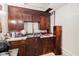 Kitchen features dated wooden cabinetry, tile countertops, and stainless steel sink at 2549 Emerald Dr, Jonesboro, GA 30236