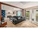 A spacious living room with a fireplace, black sofa and a view to the backyard at 2549 Emerald Dr, Jonesboro, GA 30236