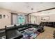 Living room featuring a black sectional sofa, glass table, and carpeted floors at 2549 Emerald Dr, Jonesboro, GA 30236