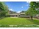 Expansive backyard with lush green lawn, mature trees, and a patio perfect for entertaining at 3019 Haverford Se Ln, Marietta, GA 30067