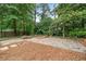 Backyard patio with stone pavers, wooden pergola, brick seating wall and manicured landscaping at 3019 Haverford Se Ln, Marietta, GA 30067