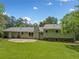 Large backyard featuring a patio, lush lawn, and mature trees for privacy and shade at 3019 Haverford Se Ln, Marietta, GA 30067