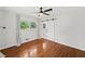 Bright bedroom with hardwood floors, ceiling fan, and sliding barn door leading to ensuite at 3019 Haverford Se Ln, Marietta, GA 30067