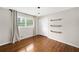 Bright bedroom featuring hardwood floors, closet, and window with modern curtain accents at 3019 Haverford Se Ln, Marietta, GA 30067
