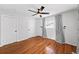Bedroom with hardwood floors, ceiling fan, and shiplap accent wall complemented by elegant curtains at 3019 Haverford Se Ln, Marietta, GA 30067