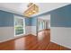 Charming dining room featuring hardwood floors and wainscoting details with a contemporary light fixture at 3019 Haverford Se Ln, Marietta, GA 30067