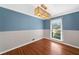 Dining room with hardwood floors, shiplap walls, and ample natural light from the large window at 3019 Haverford Se Ln, Marietta, GA 30067