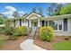Inviting front entrance with stone steps, blue door, and well-manicured landscaping at 3019 Haverford Se Ln, Marietta, GA 30067