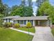 Charming one-story house featuring a spacious driveway, manicured lawn, and attached carport at 3019 Haverford Se Ln, Marietta, GA 30067