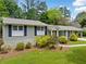 Charming single-story home with light colored brick, blue shutters, mature landscaping, and a welcoming walkway at 3019 Haverford Se Ln, Marietta, GA 30067