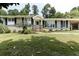 Charming ranch-style home featuring a well-manicured front yard, a covered entry, and shuttered windows at 3019 Haverford Se Ln, Marietta, GA 30067