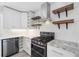 Modern kitchen featuring granite countertops, stainless steel appliances, and open shelving at 3019 Haverford Se Ln, Marietta, GA 30067