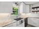 Bright kitchen featuring stainless steel farmhouse sink, granite countertops, and white subway tile backsplash at 3019 Haverford Se Ln, Marietta, GA 30067