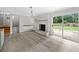 Inviting living room featuring a white brick fireplace and access to a well-manicured backyard at 3019 Haverford Se Ln, Marietta, GA 30067