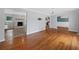 Spacious living room featuring hardwood floors, a stone fireplace, and a seamless flow to the kitchen at 3019 Haverford Se Ln, Marietta, GA 30067