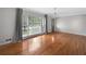 Bright living room with hardwood floors, large windows, and neutral wall paint at 3019 Haverford Se Ln, Marietta, GA 30067