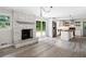 Bright living space showcasing brick fireplace and open layout with modern kitchen at 3019 Haverford Se Ln, Marietta, GA 30067