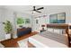Stylishly furnished main bedroom with hardwood floors, ceiling fan, and ample natural light at 3019 Haverford Se Ln, Marietta, GA 30067