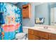 Quirky bathroom featuring a cheerful shower curtain, wooden cabinets, and a standard toilet at 49 Timberlake Ne Cv, Cartersville, GA 30121