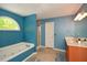 Bright bathroom with a soaking tub, walk-in shower, and a vanity with sink at 49 Timberlake Ne Cv, Cartersville, GA 30121