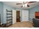 Bedroom featuring neutral carpeting, shelves, and standard closet, with view into hallway at 49 Timberlake Ne Cv, Cartersville, GA 30121