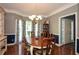Traditional dining room with hardwood floors, chandelier, and elegant wainscoting, ideal for entertaining at 49 Timberlake Ne Cv, Cartersville, GA 30121